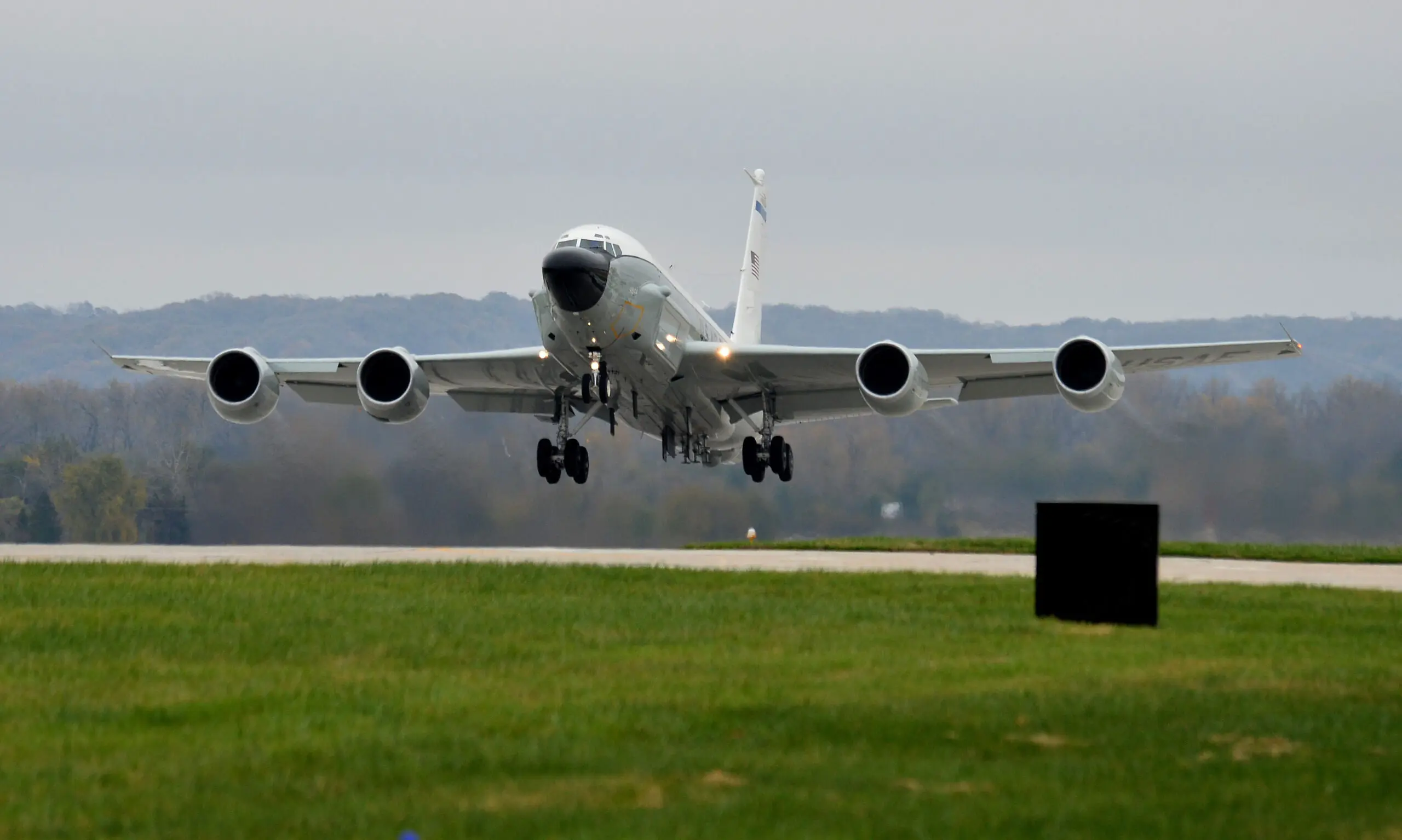 A large airplane flying low to the ground.