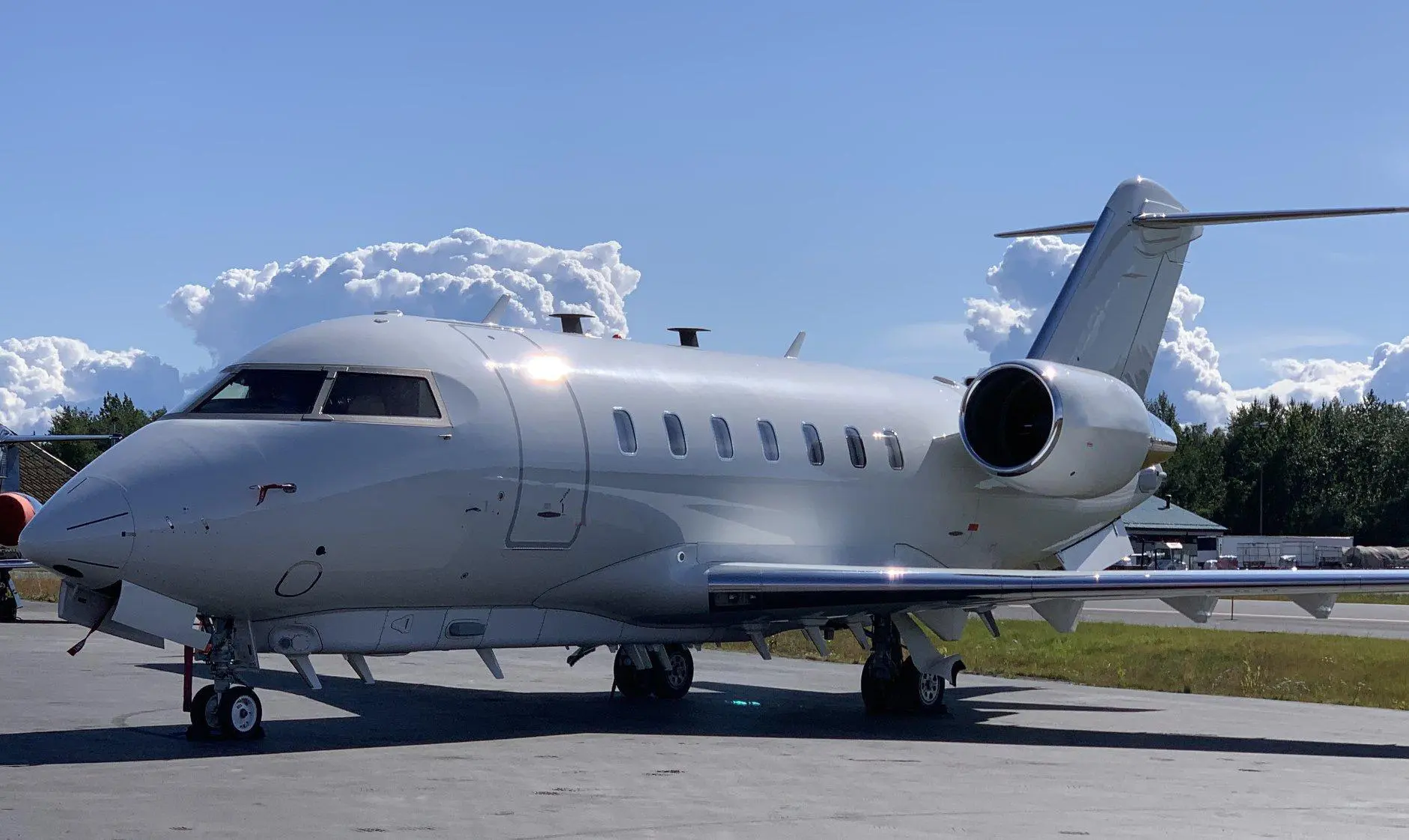 A large white airplane sitting on top of an airport runway.